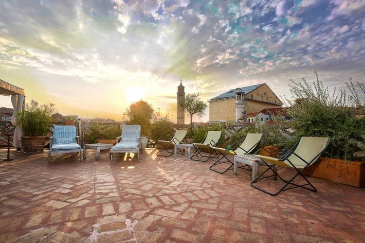 Rooftop at sunset with lounge chairs